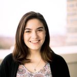 a white woman with brunette hair smiling headshot
