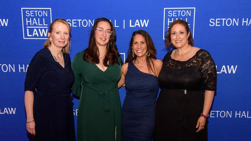 Four white women posing together