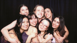 Group of women holding each other and posing