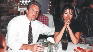 A white couple seated at a dinner table