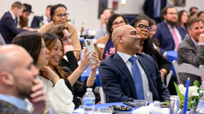 diverse people seated laughing