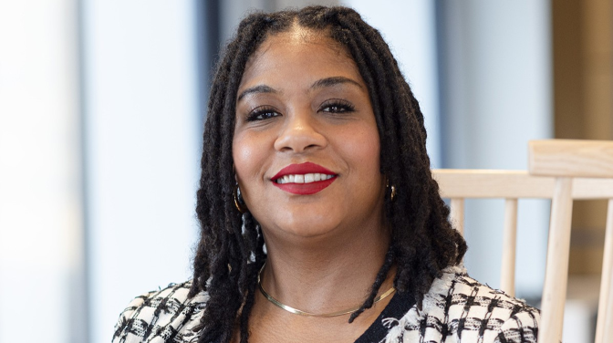 black woman wearing red lipstick and suit
