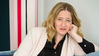 white woman gazing while resting her face on one hand