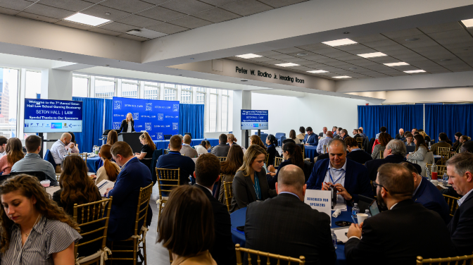 A crwoded room of people seated at a conference