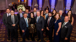 group of people pose in a ballroom