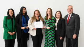 group of women and a man posing