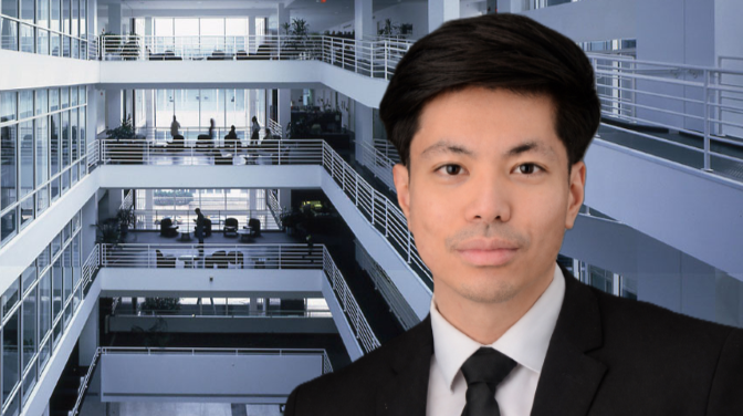 Man in front of building interior with railings