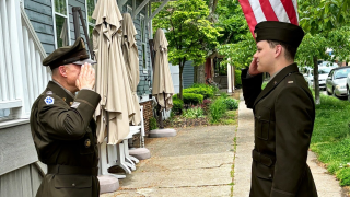 Two men in uniform saluting each other