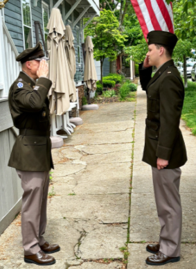 two men in uniform saluting each other
