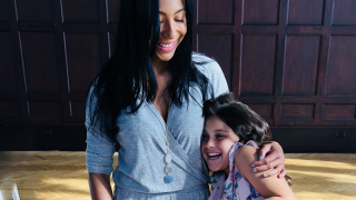 a woman and a girl holding each other smiling