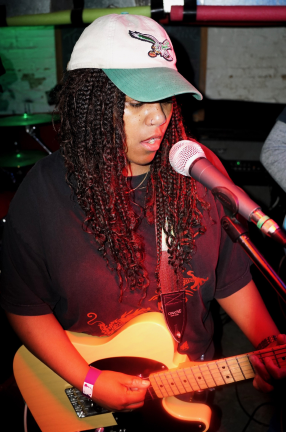 black woman playing guitar