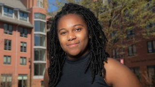 black woman in front of trees
