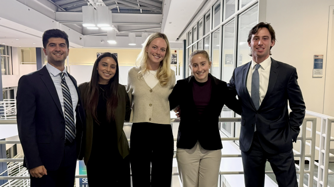 five people posing smiling