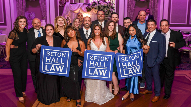 A woman in a wedding dress posing with a group 