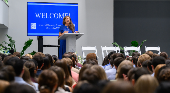 woman speaking before blue background