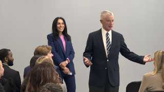 White man speaking to seated audience