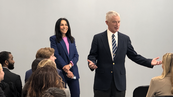 white man speaking to seated audience