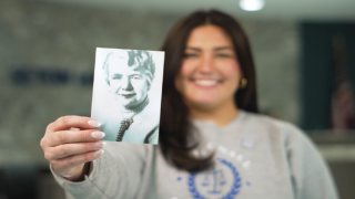 a woman holding a photo smiling