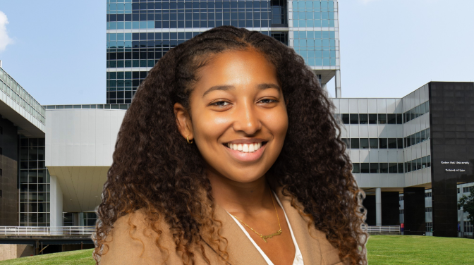 black woman smiling in front of buildings