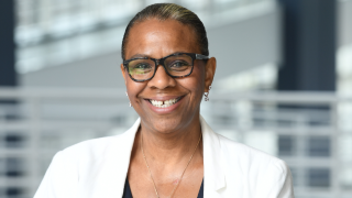 Bespectacled Black woman smiling