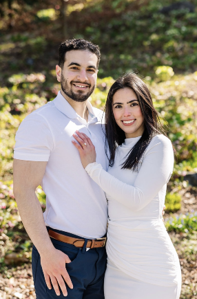 man and woman holding each other posing