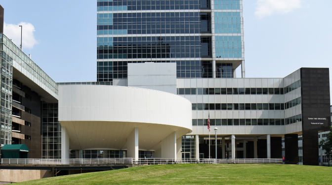 A white building across green grass
