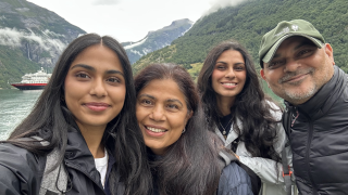 Four people smiling in nature setting