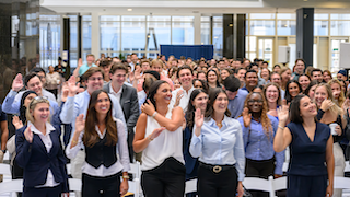 students swearing in with their hands up