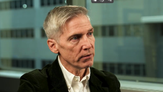 white man in front of a glass window