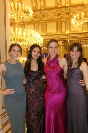 group of young women pose in dress