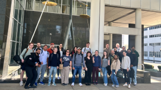 group of students pose on campus