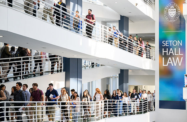 students walking on ramp in atrium