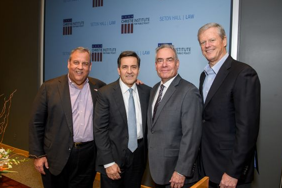 Four white men standing together posing 