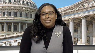 Black woman with glasses smiling
