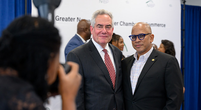 Photographer taking picture of two men standing together