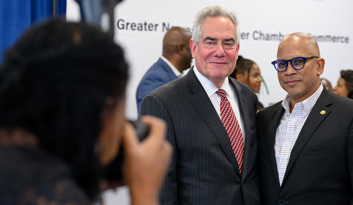 Photographer taking a picture of two people