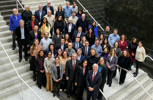Faculty members smiling in group photo