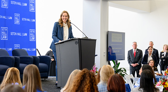 white woman speaking at the podium