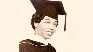 Black female graduate wearing a cap
