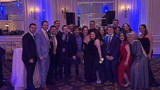 A photo of a group of people posing at a reception.