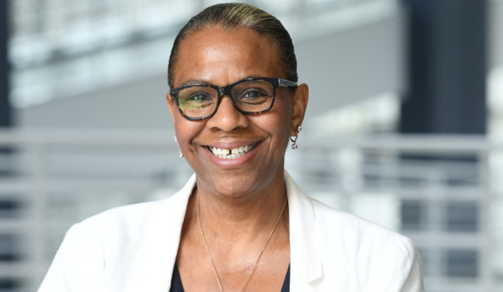 African American woman with glasses smiling