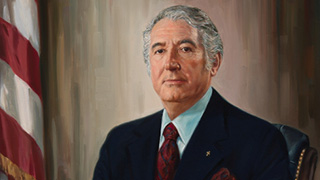 whiteman seated holding a book